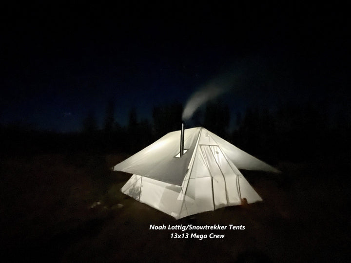 Snowtrekker 13x13 Mega Crew With Tent Fly at Night with Light In Tent Smoke Exiting Stove Pipe