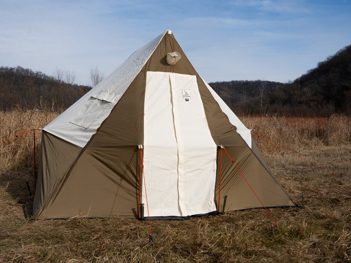 Beige and white tent in a field