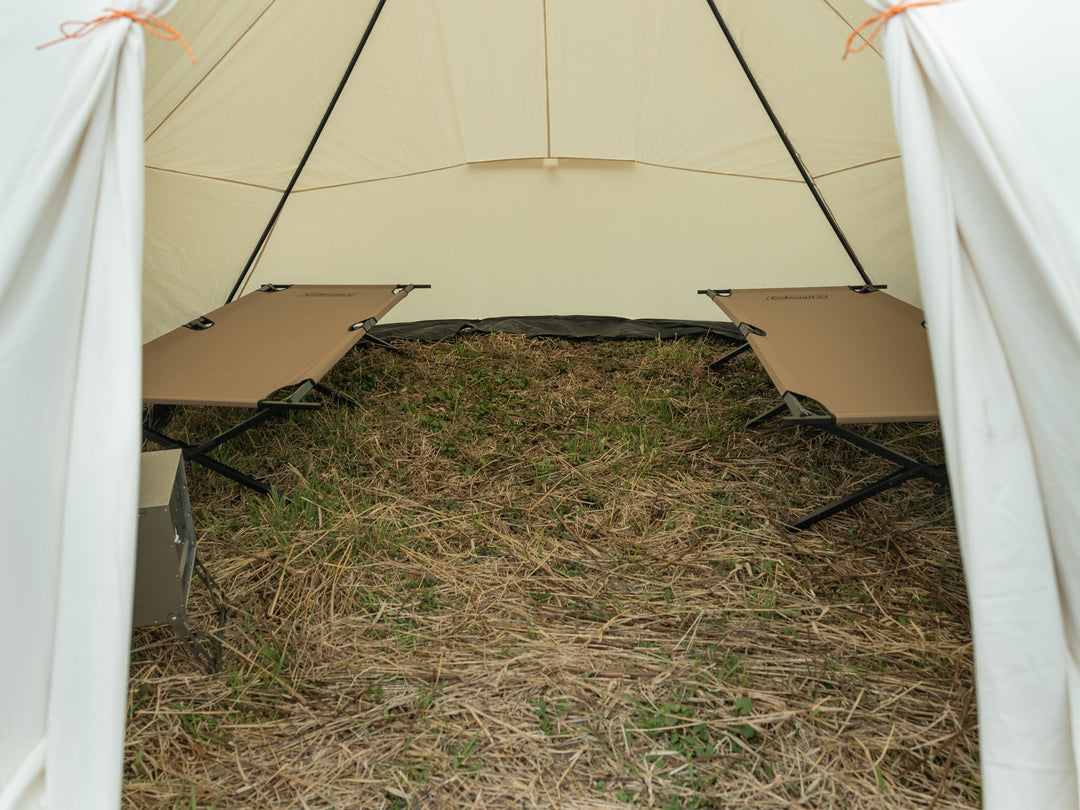 Snowtrekker 13x18 Mega Crew Looking Inside through door stove partially visible front left corner two tan cots setup along left and right sidewall of tent