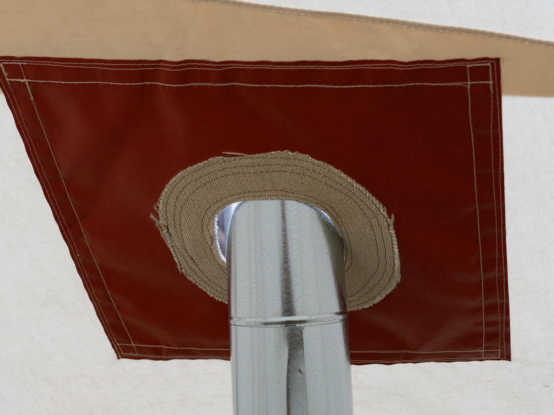 Close-up of a stove pipe with passing through a stove jack gasket