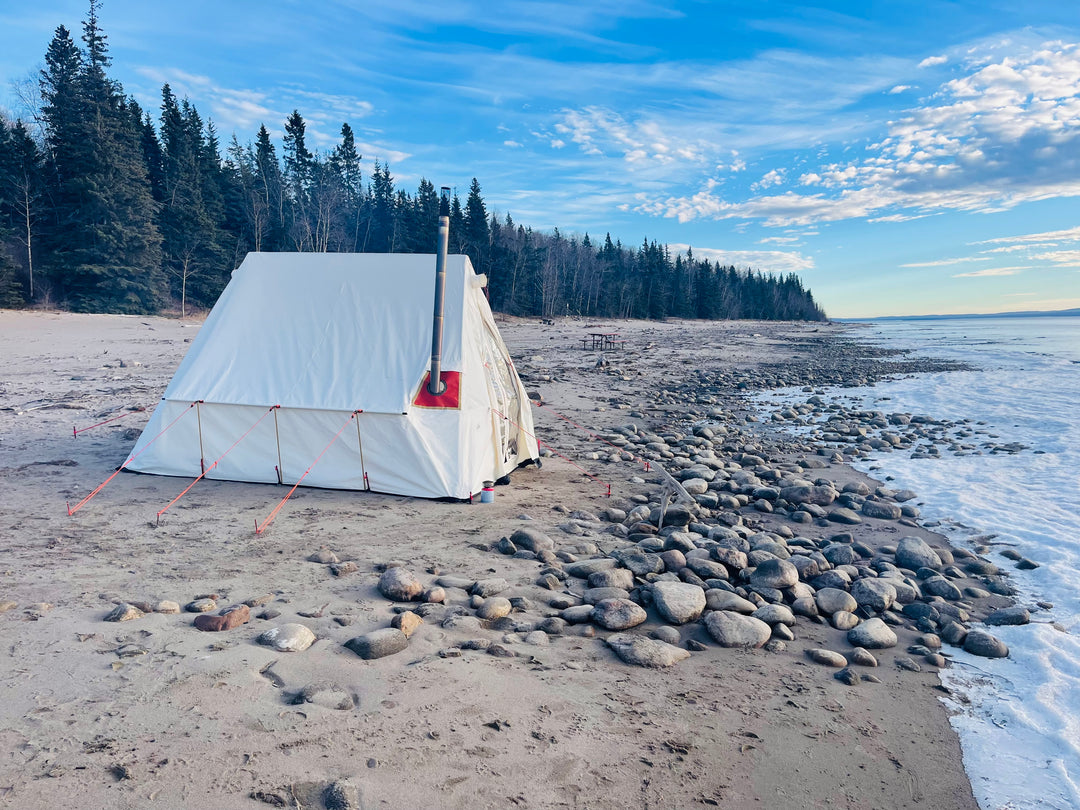 Snowtrekker 9x11.5 Basecmap Setup On Slave Lake Shore in canada on sand beach with pine trees in background next to frozen lake