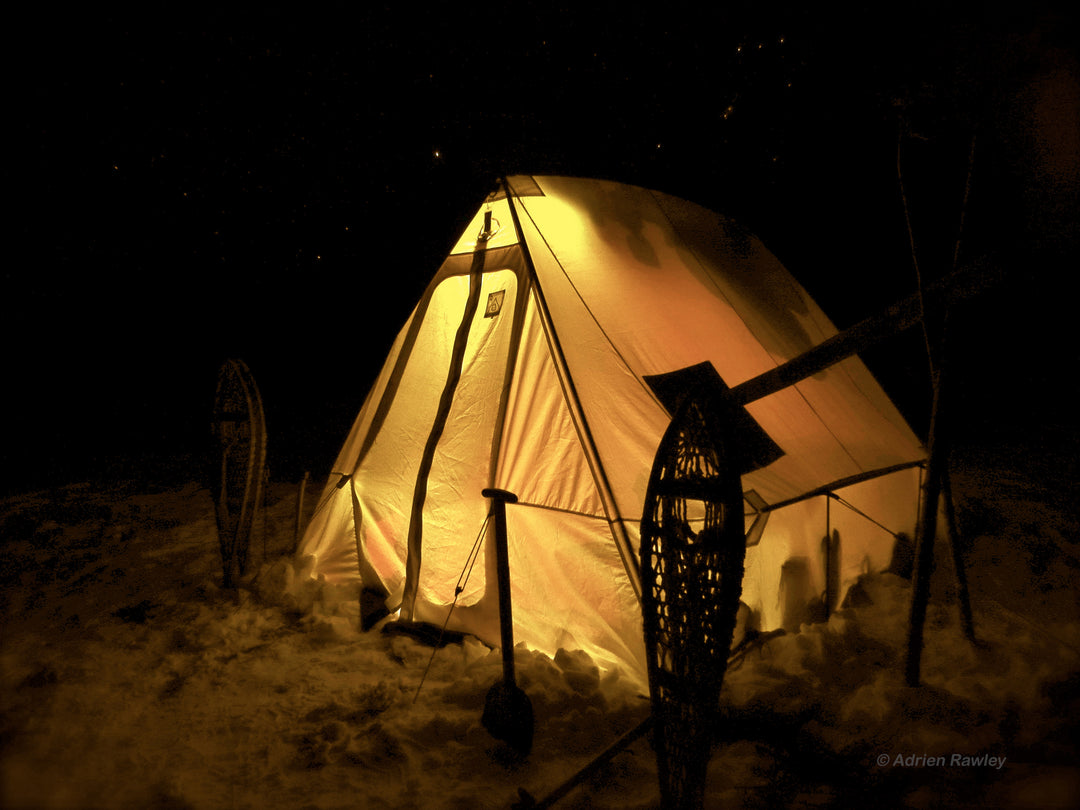 Snowtrekker 8x10 Shortwall Setup In Winter At Night with Lights In Tent snowshoes on either side of the tent