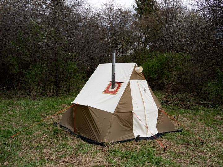 Camping tent with chimney in a natural setting
