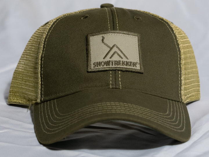 Green cap with a Snowtrekker patch on a white background