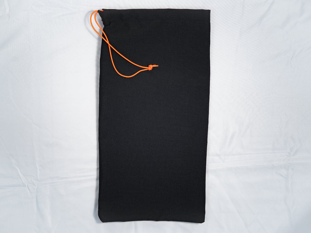 Black drawstring bag with orange drawstring on a white background
