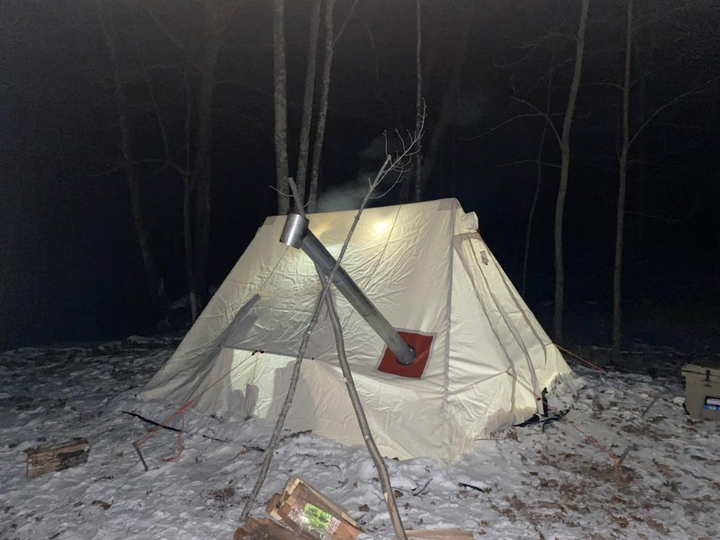 Dick Edwards' Snowtrekker Tent in the snowy woods at night