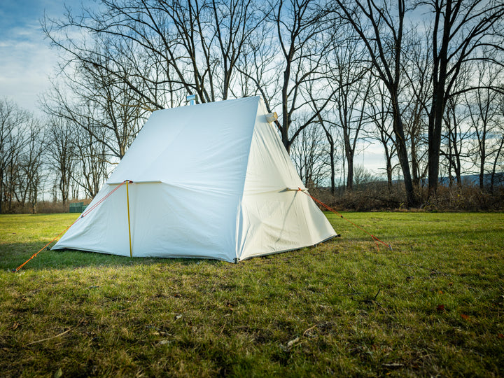 Snowtrekker 9.5x9.5 High Country right Side and Rear View of tent setup on green grass with trees in background