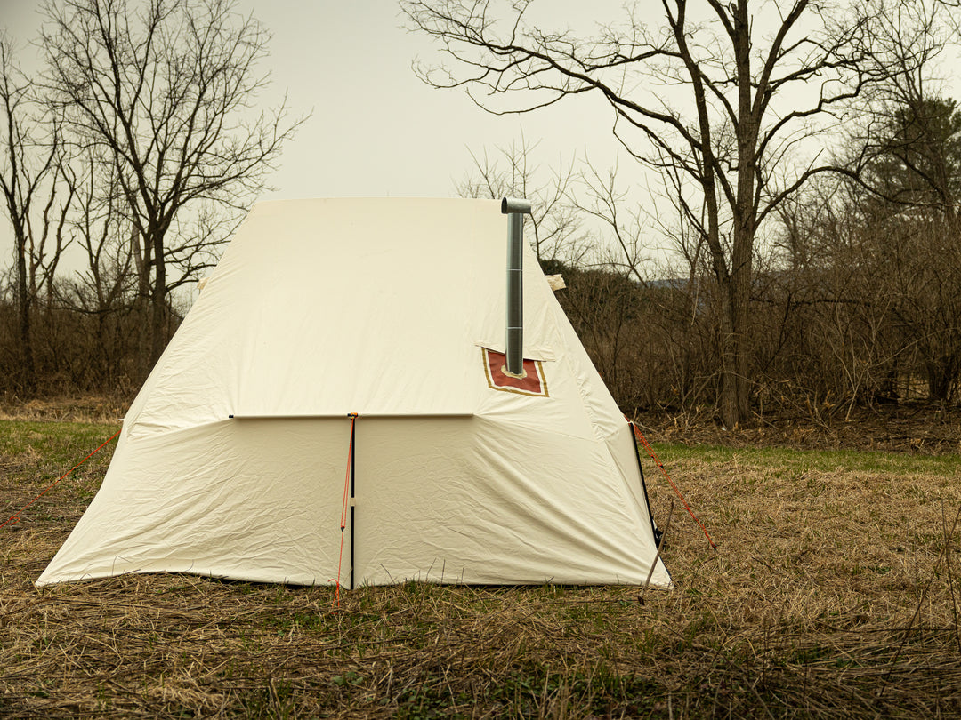 Snowtrekker 13x13 Mega Crew Side View Stove Pipe Exiting Tent vertically with spark arrester on top of stove pipe trees in background