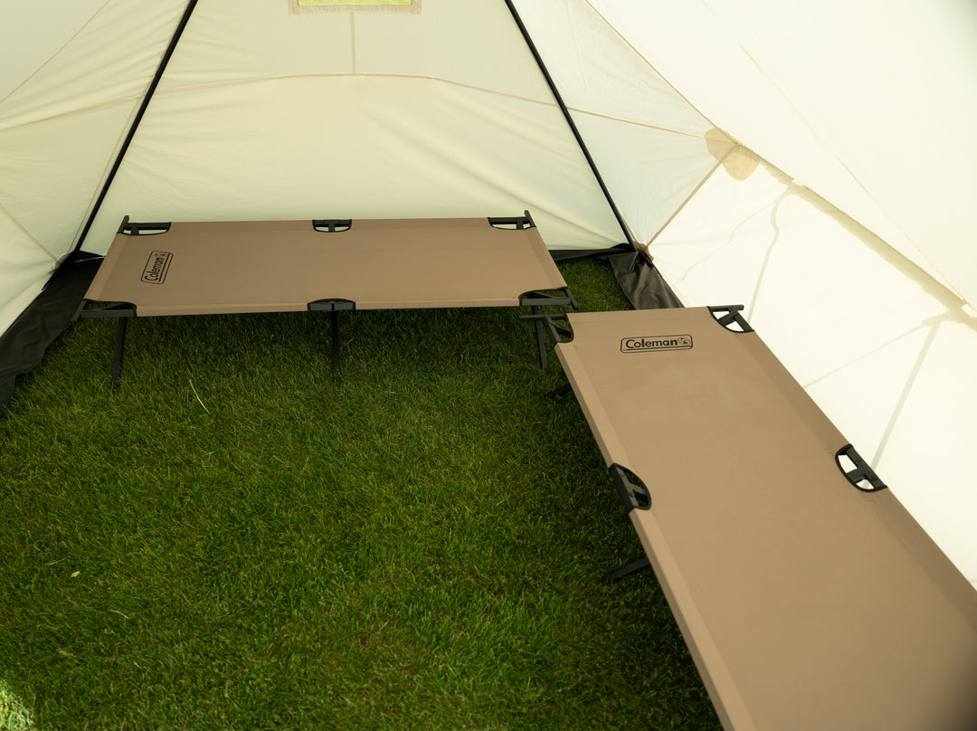 Looking Inside Snowtrekker 10x13 Outfitter Showing Two tan Cots  one along the right side of the tent and one along the backwall of the tent