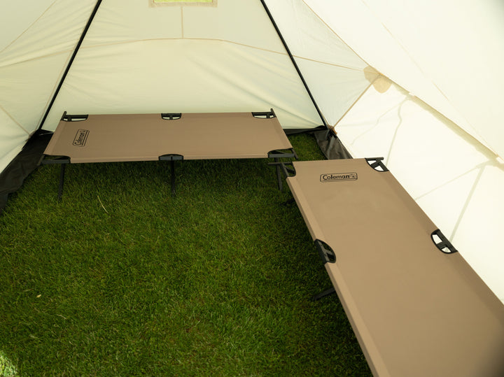 Looking Inside Snowtrekker 10x13 Outfitter Showing Two tan Cots  one along the right side of the tent and one along the backwall of the tent