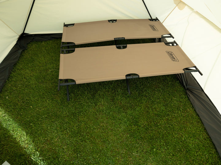 Looking Inside Snowtrekker 10x13 Outfitter Showing Two tan Cots setup side by side to the right of the tent along the backwall