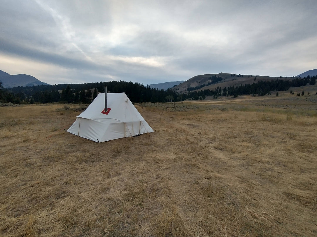 Snowtrekker 11x11 High Country Setup In Montana Meadow with pine tress and moutains in background