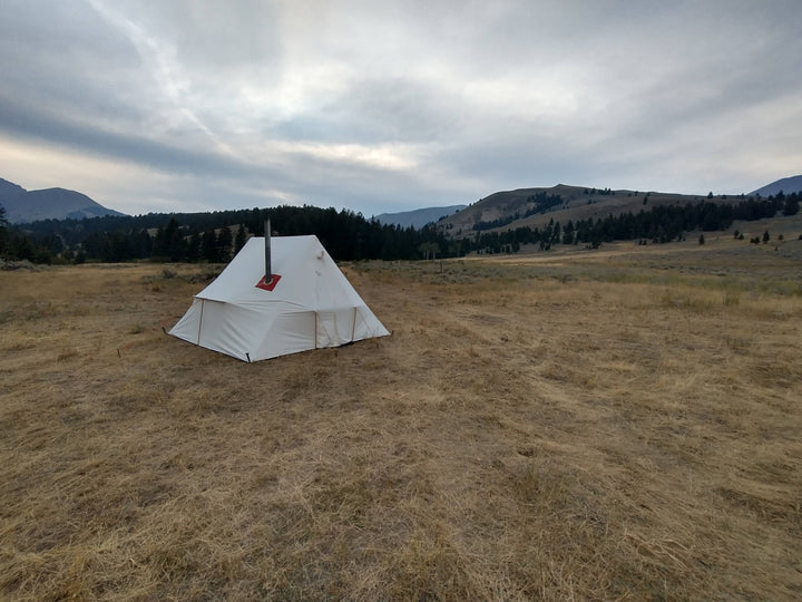 Snowtrekker 11x11 High Country Setup In Montana Meadow with pine tress and moutains in background