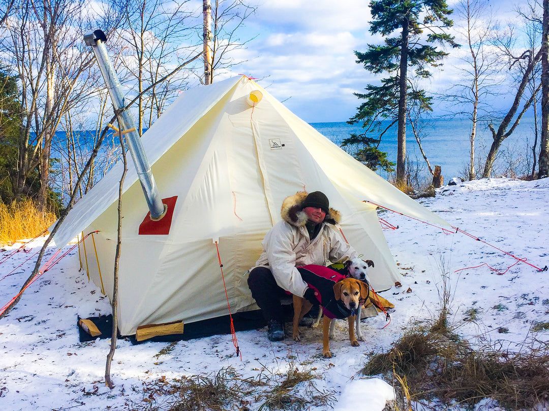 Snowtrekker 9x11.5 Shortwall With Tent Fly setup On Lake Shore snow on ground man in front of tent with two dogs