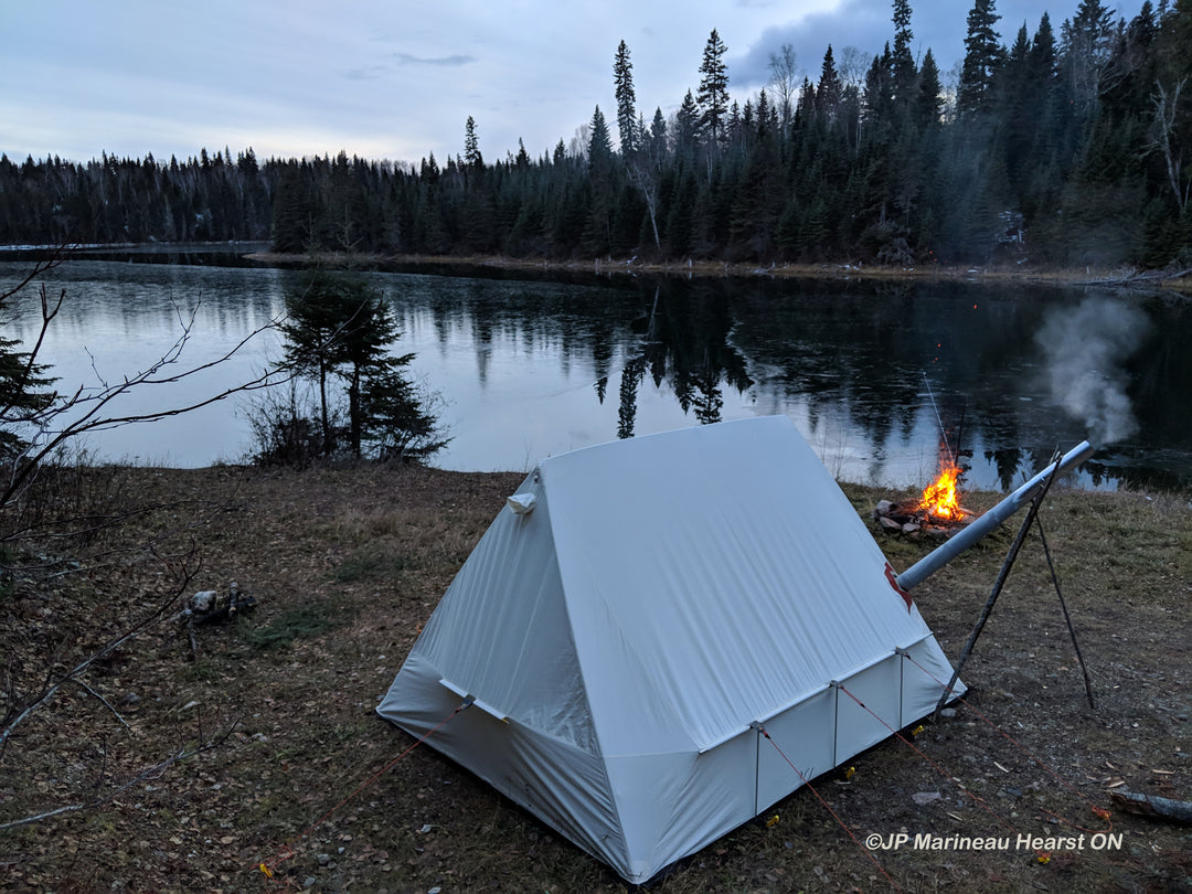 Snowtrekker 9x11.5 Shortwall On Lake Shore With Campire and Smoke Coming Out of Stove Pipe