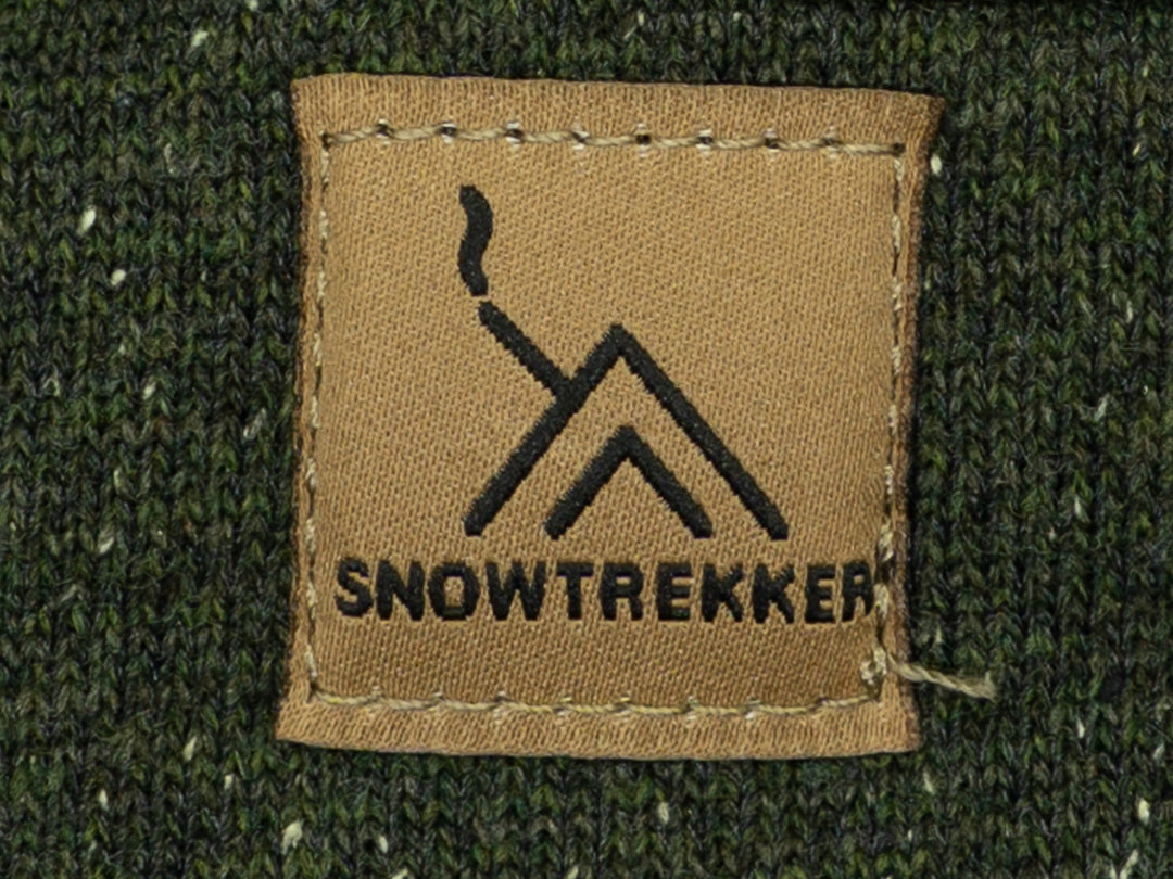 Snowtrekker logo on a brown patch against a green fabric background