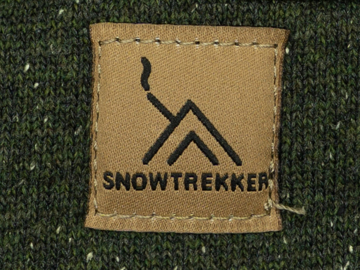 Snowtrekker logo on a brown patch against a green fabric background
