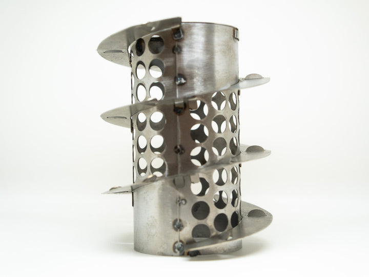 Metallic perforated object on a white background