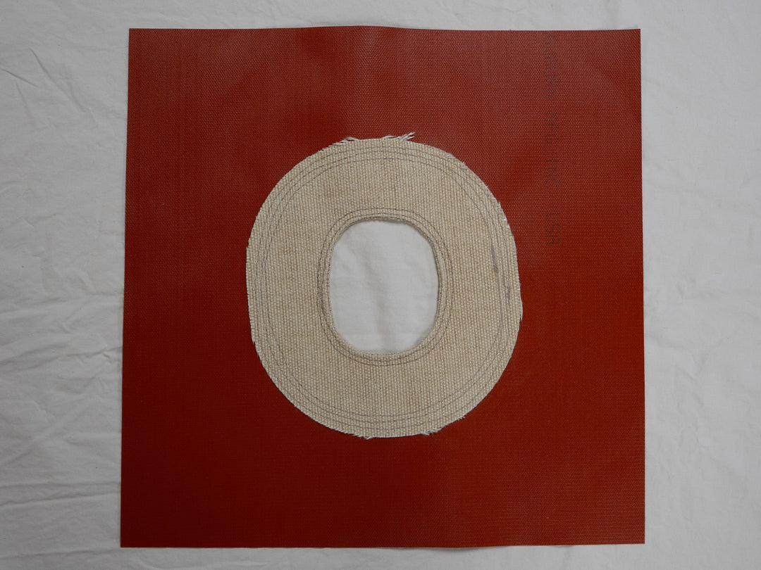 Beige circular object on a red background