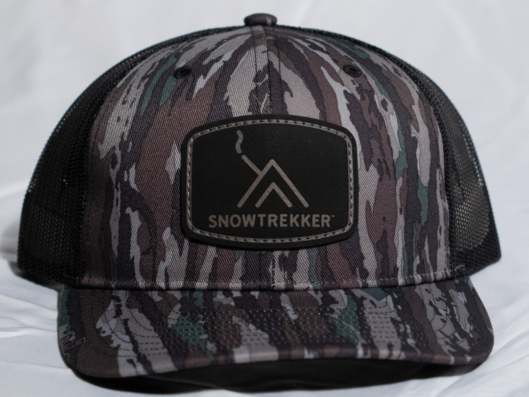 Camouflage cap with SnowTrekker logo on a white background