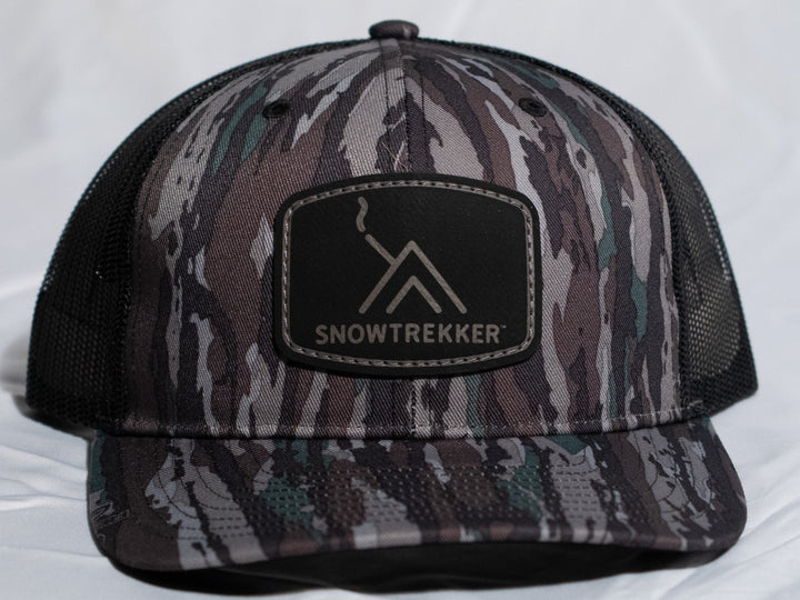 Camouflage cap with SnowTrekker logo on a white background