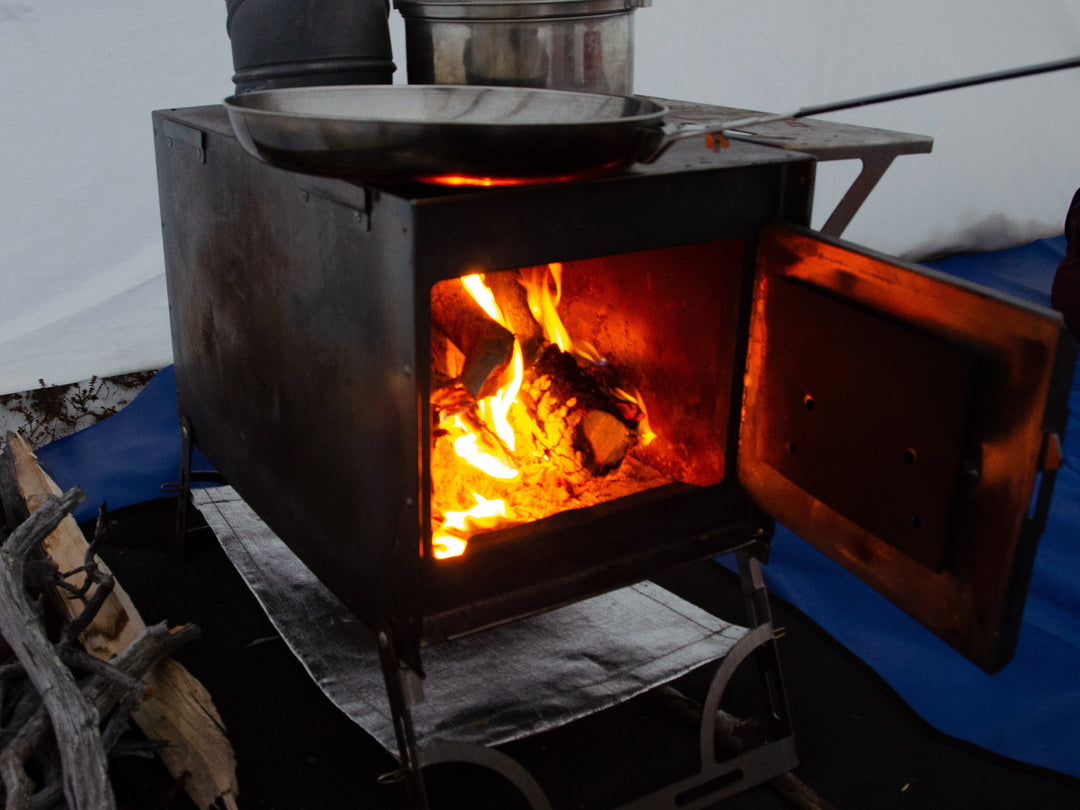 Stove with door open and fire going inside 