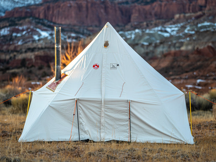 White camping tent with logos in a desert landscape