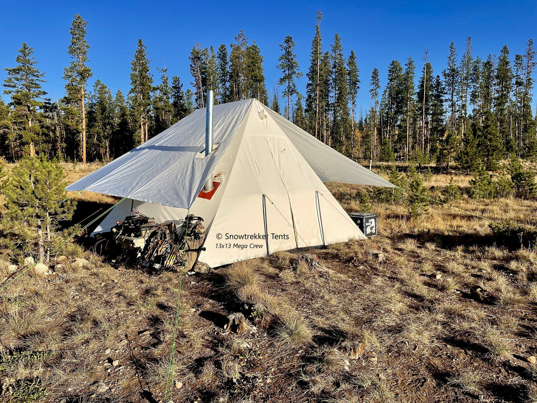 Snowtrekker 13x13 Mega Crew Setup With Tent Fly Archery Equipment Next To Tent in Colorado mountain meadow with pine trees in background